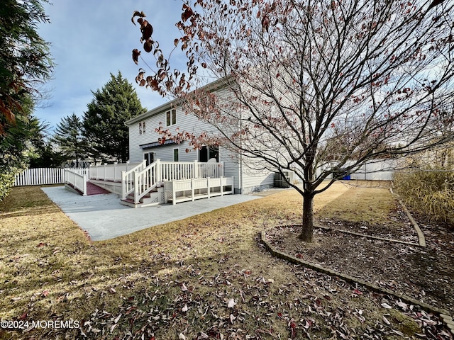 back of house with a patio, a lawn, and fence