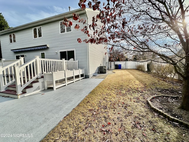 view of side of property with fence and central AC unit