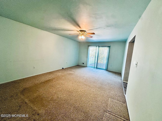 carpeted empty room with a ceiling fan