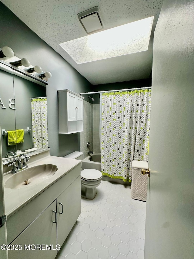 bathroom with tile patterned flooring, a skylight, vanity, visible vents, and shower / bathtub combination with curtain