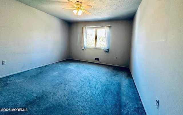 spare room featuring a textured ceiling, ceiling fan, carpet, and baseboards