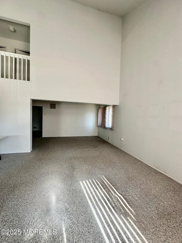 unfurnished room featuring a high ceiling