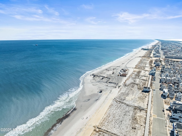 bird's eye view with a water view and a beach view