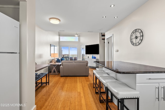 living area with recessed lighting and light wood finished floors