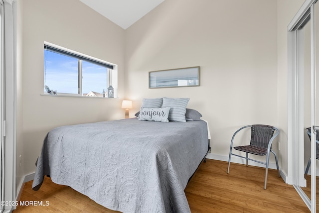 bedroom featuring wood finished floors and baseboards