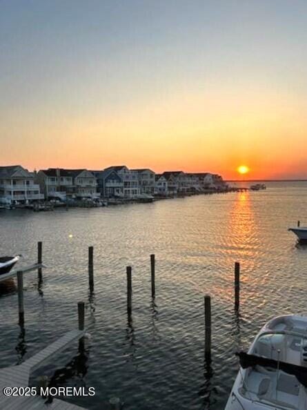 view of dock featuring a residential view and a water view