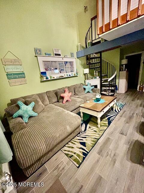 living room featuring wood finished floors and stairs