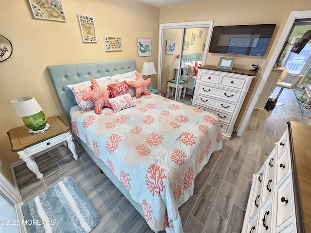 bedroom with a closet and wood finish floors