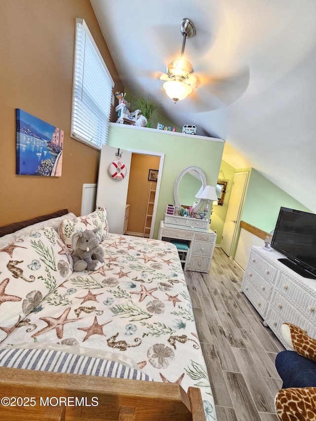 bedroom featuring wood finished floors and vaulted ceiling