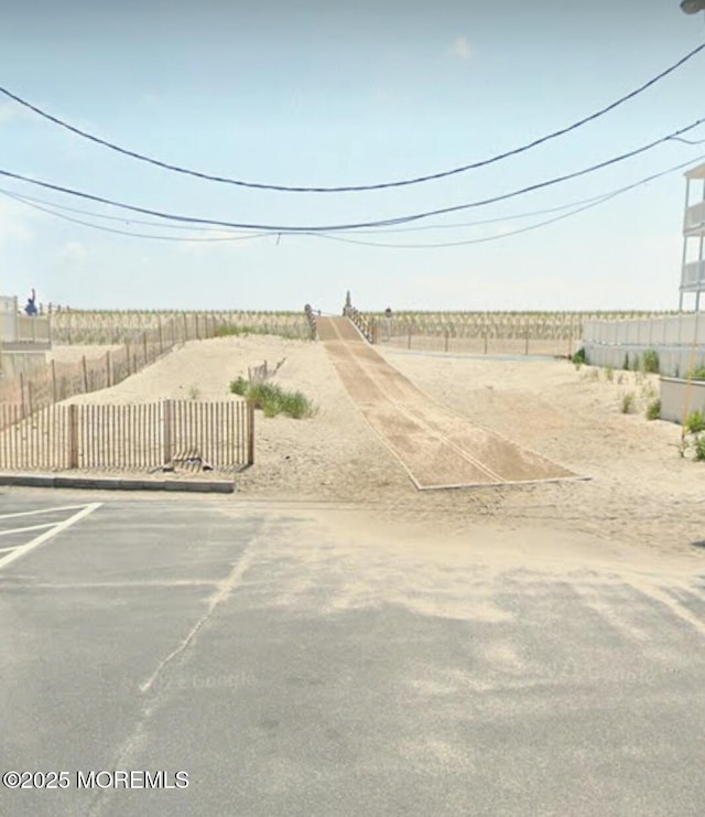 view of yard with a rural view and fence