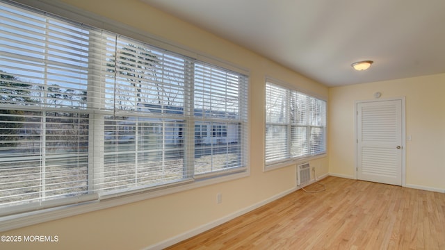 spare room with wood finished floors and baseboards