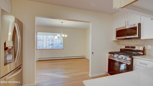 kitchen featuring a baseboard heating unit, backsplash, stainless steel appliances, white cabinets, and light countertops