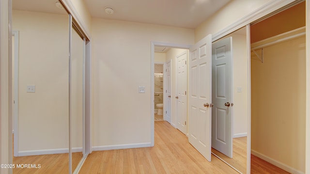 unfurnished bedroom featuring light wood finished floors and baseboards