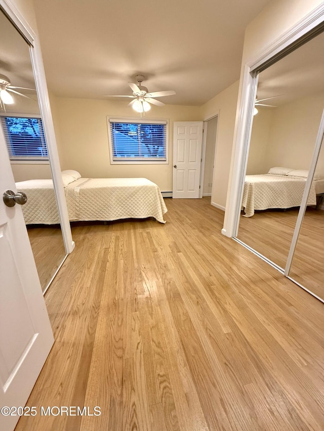 unfurnished bedroom featuring a ceiling fan, light wood-style floors, and a closet