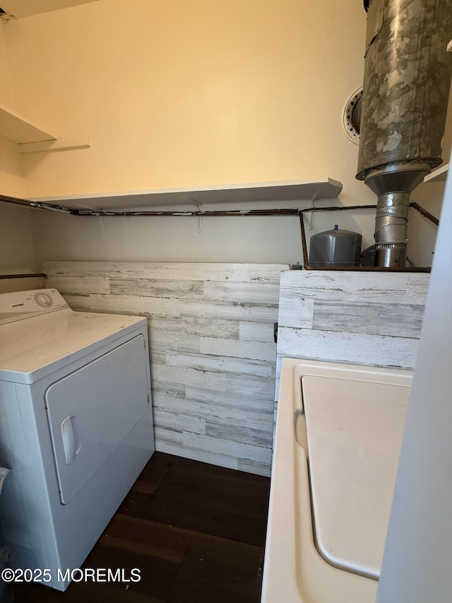 laundry area featuring laundry area, washer / clothes dryer, dark wood-style flooring, and wainscoting