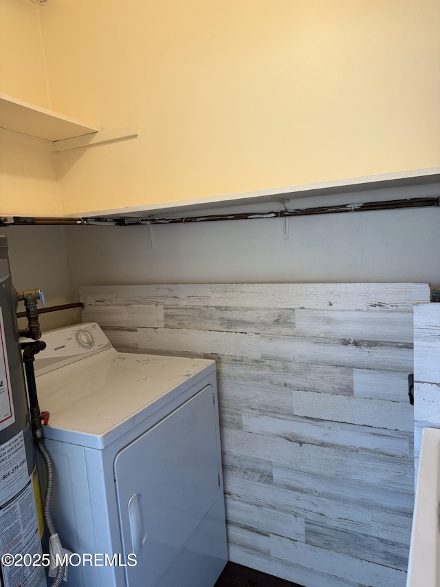 laundry area featuring gas water heater, washer / dryer, and laundry area