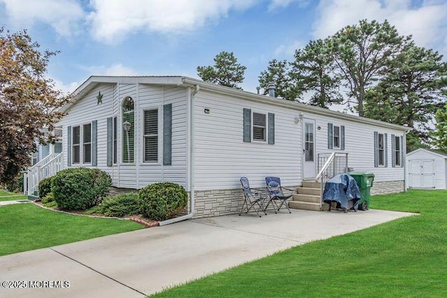 exterior space featuring an outbuilding, a storage shed, and a front yard