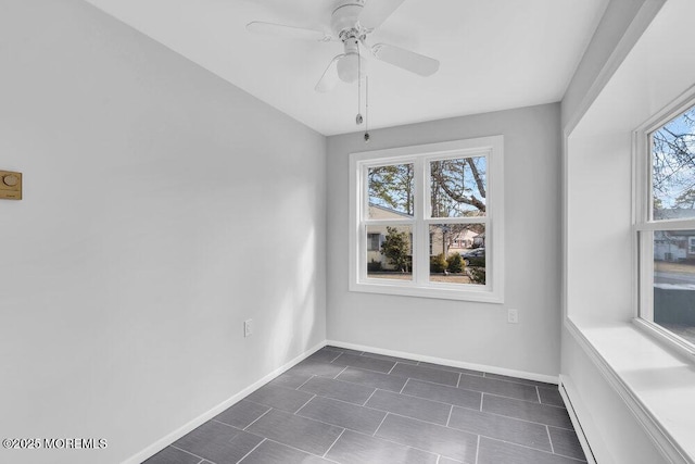 empty room with baseboards and a ceiling fan