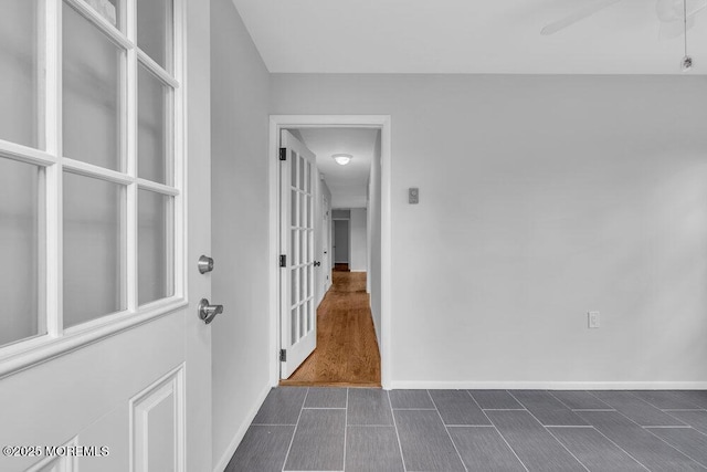 interior space with ceiling fan and baseboards