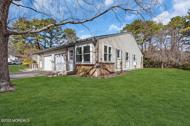 view of home's exterior featuring an attached garage, brick siding, aphalt driveway, and a yard