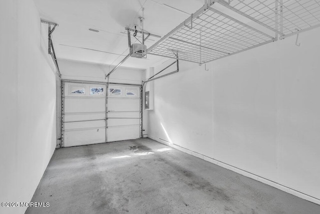 garage with a garage door opener and electric panel