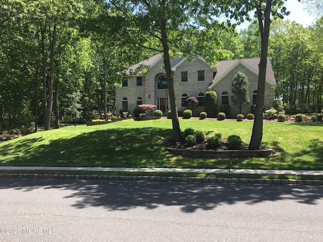 view of front of house featuring stone siding and a front yard