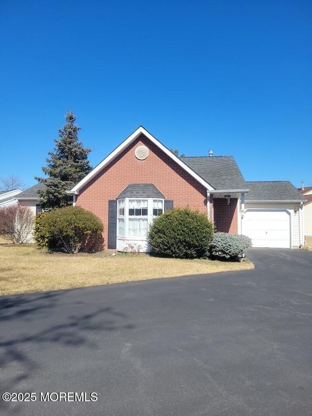 view of front of home featuring an attached garage and brick siding