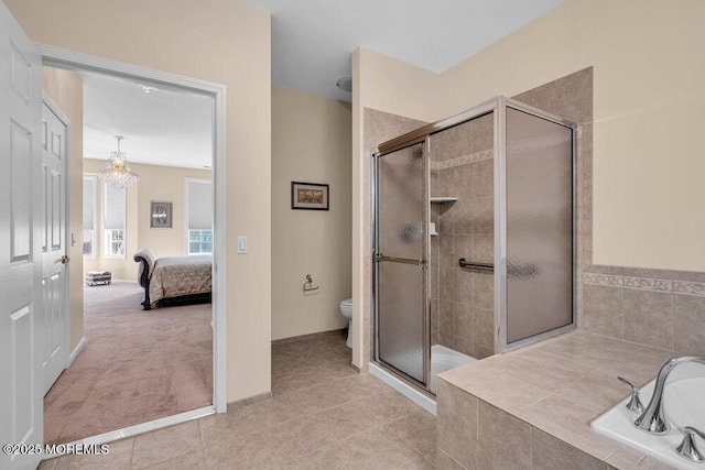 ensuite bathroom featuring a stall shower, connected bathroom, toilet, tile patterned flooring, and tiled tub