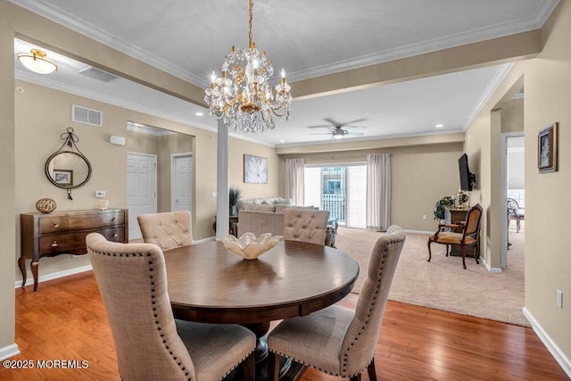 dining room featuring light wood-type flooring, baseboards, visible vents, and crown molding