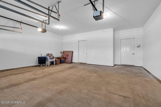 garage with baseboards and a garage door opener