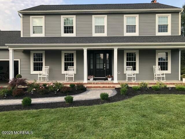 view of front of home featuring a porch and a front lawn