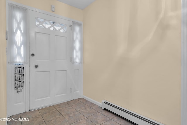 foyer with light tile patterned floors, a baseboard radiator, and baseboards