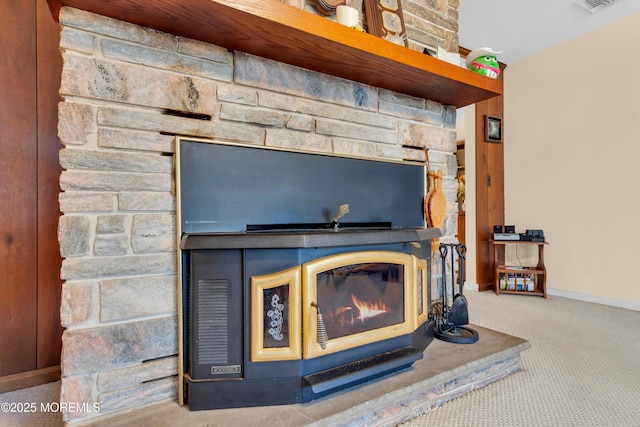 room details featuring carpet floors, a glass covered fireplace, visible vents, and baseboards