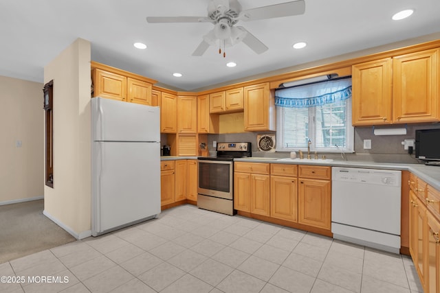 kitchen with white appliances, baseboards, light countertops, a sink, and recessed lighting