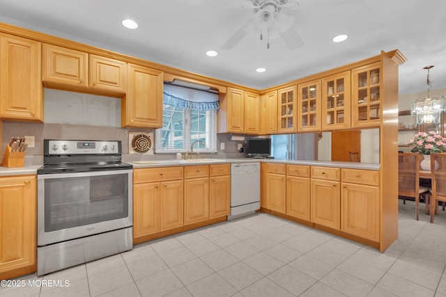 kitchen featuring stainless steel electric range oven, glass insert cabinets, white dishwasher, light countertops, and a sink