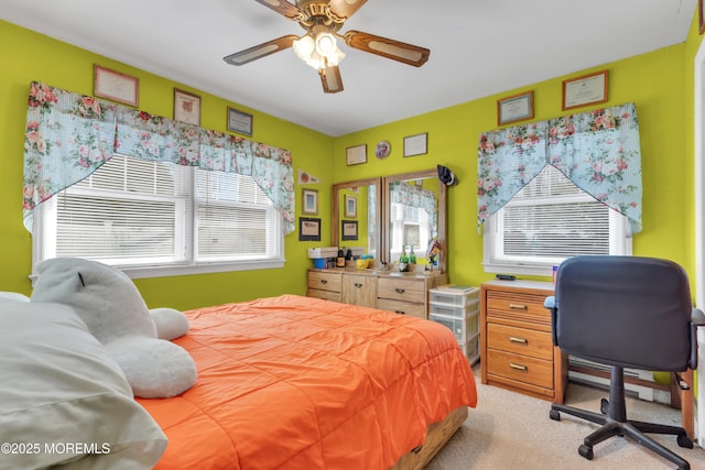 bedroom with light carpet and a ceiling fan