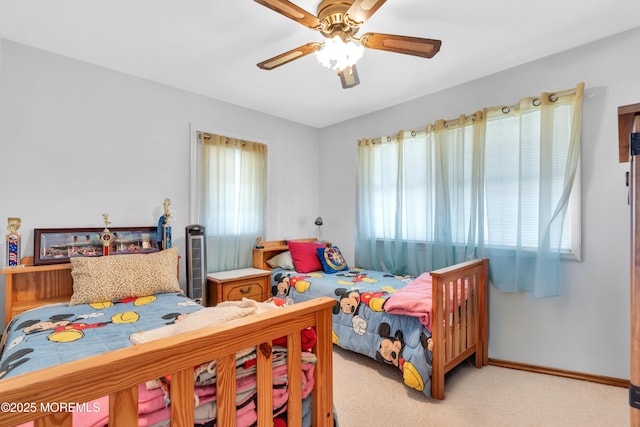 bedroom with baseboards, a ceiling fan, and light colored carpet