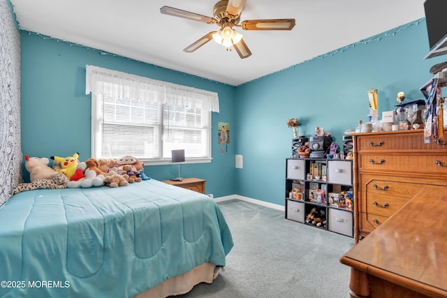 carpeted bedroom with a ceiling fan and baseboards