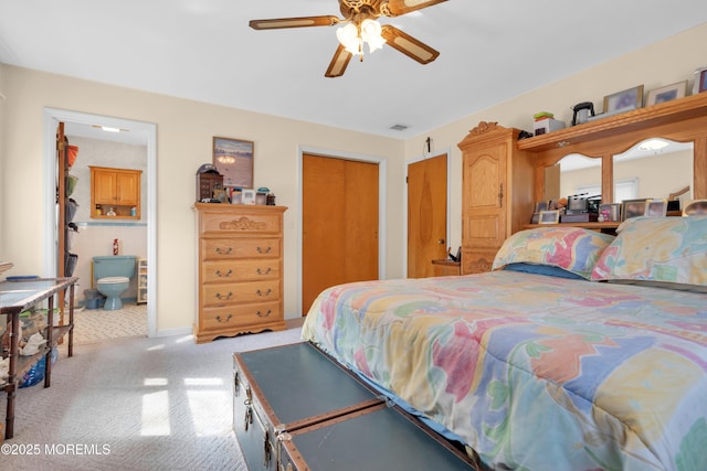 bedroom with ensuite bath, visible vents, a ceiling fan, and light colored carpet