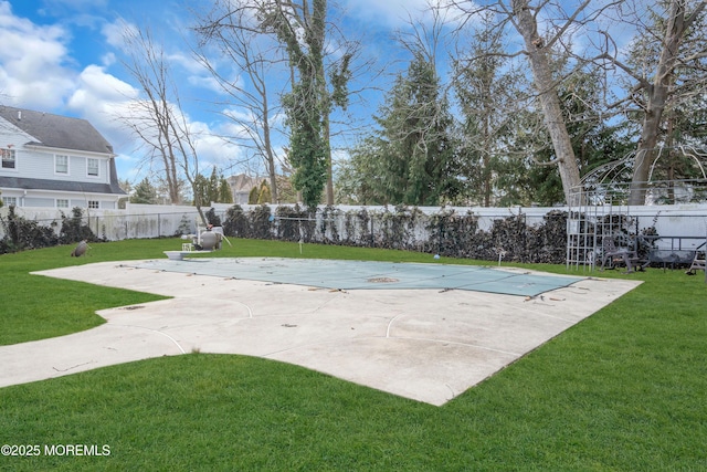 exterior space featuring a fenced backyard, a fenced in pool, and a lawn