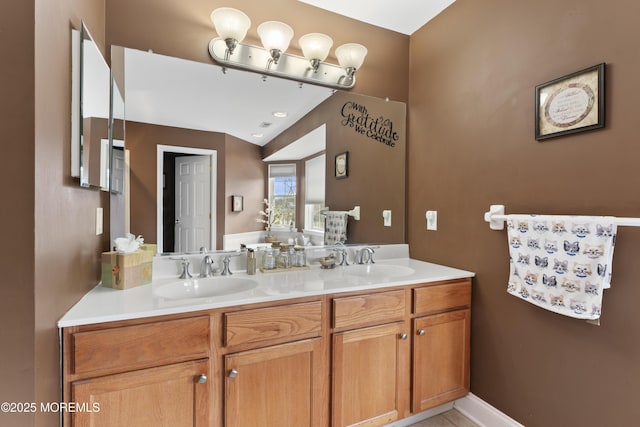 full bathroom with double vanity and a sink