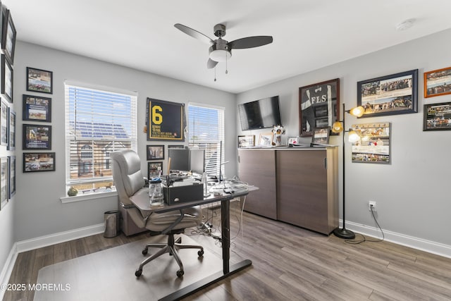 home office with wood finished floors, a ceiling fan, and baseboards