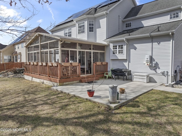 rear view of house featuring a patio area, a sunroom, and a yard