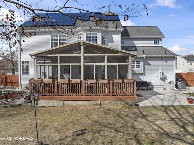 back of property featuring a patio, fence, and a sunroom