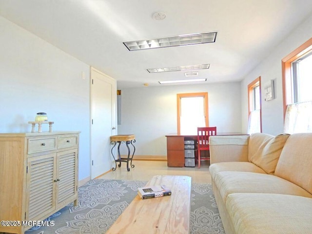 living area featuring visible vents and baseboards