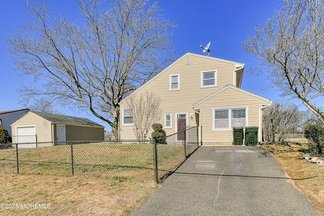 view of front of property featuring a garage and fence