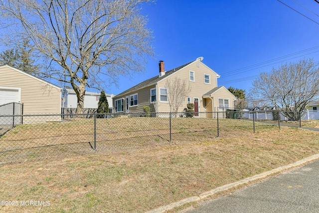 view of front of property with a chimney, fence, and a front lawn