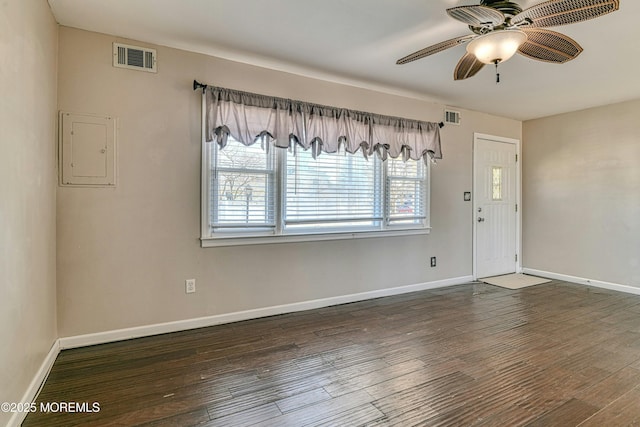 interior space featuring electric panel, visible vents, baseboards, and wood finished floors