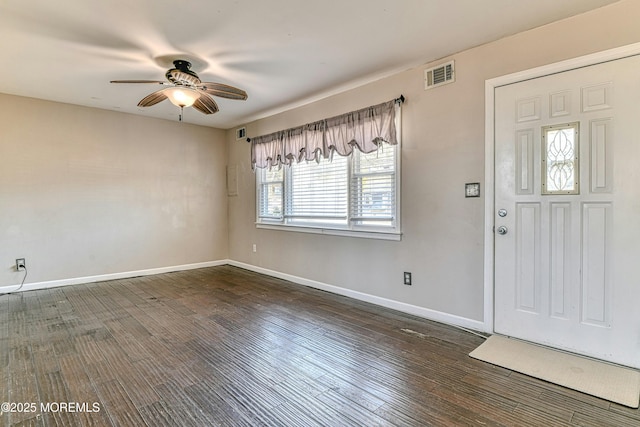 foyer with dark wood-type flooring, visible vents, baseboards, and a ceiling fan