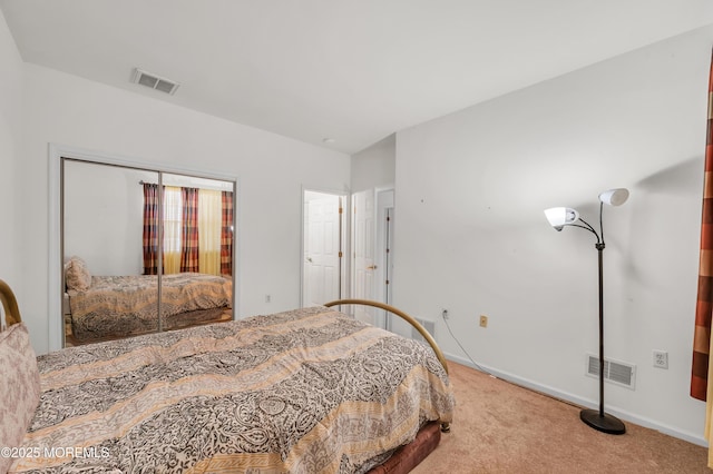 bedroom featuring carpet floors, a closet, visible vents, and baseboards